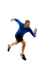 Fototapeta premium Power. Caucasian professional jogger, runner training isolated on white studio background. Muscular, sportive man, emotional. Concept of action, motion, youth, healthy lifestyle. Copyspace for ad.