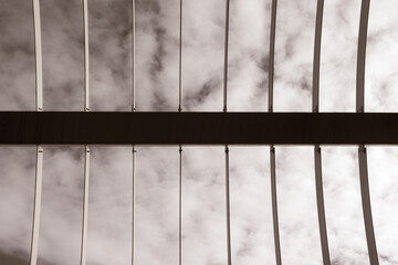 iron mesh with parallel horizontal lines on sky with clouds