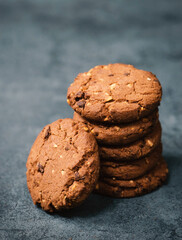 Cookies with hazelnuts and chocolate, dark moody sweets, empty copy space for text
