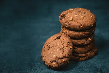 Cookies with hazelnuts and chocolate, dark moody sweets, empty copy space for text