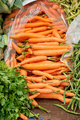 raw ripe red carrots on market counter