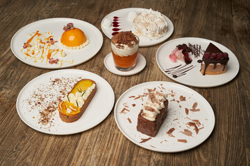 Dessert table with cupcake, mousse, biscuits, cheesecake.