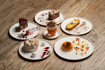 Dessert table with cupcake, mousse, biscuits, cheesecake.