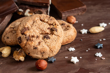 Organic food snack tasty sweet dessert milk dark chocolate chip salt cookie closeup piece fruit orange raspberry hazelnut nuts cinnamon on cocoa cacao powder wooden table for new year Christmas gift