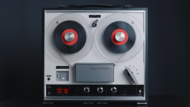 Reel to reel tape recorder playing rewind. Rotating vintage music player close up. Retro tape. Spinning reels metallic color. Party. Loop. Front view. Front view. Popular Disco Trends 60s, 70s, 80s