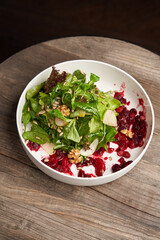 Spinach salad in a white bowl. Healthy diet salad