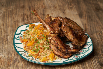 Roasted turkey and couscous on wooden table background