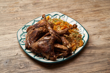 Roasted turkey and couscous on wooden table background
