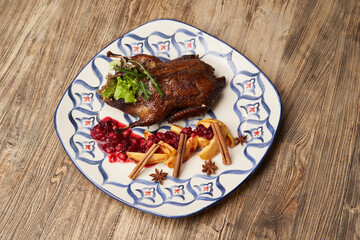 Roasted duck with quince on wooden table background