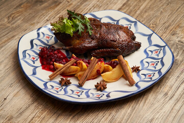 Roasted duck with quince on wooden table background