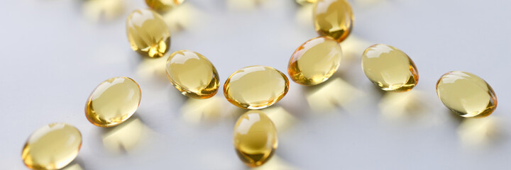 Shiny fish oil nutrition, omega 3,6,9 for good health lie in the shape of the sun closeup. Prevention of rickets regular intake of vitamin D concept.