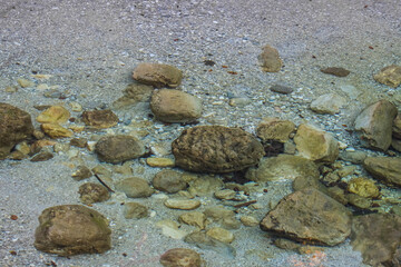 stones in clear mountain water while hiking