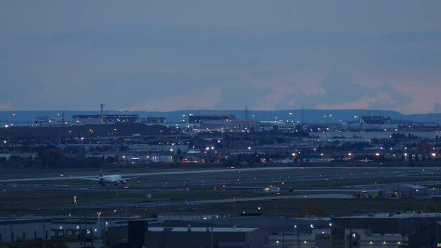 Huge plane taking off from Toronto Pearson Airport during blue hour