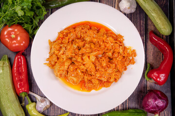 Delicious baked meat with cabbage on a plate on the wooden table