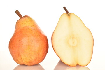One whole and one half of a red pear, close-up, isolated on white.