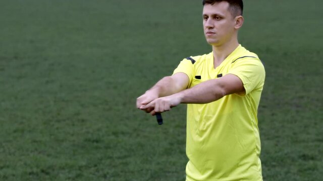 Referee goes watching VAR or violation of the rules and shows a penalty, yellow or red card . Concept of sport, rules violation, offside