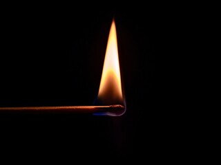 burning match on black background
