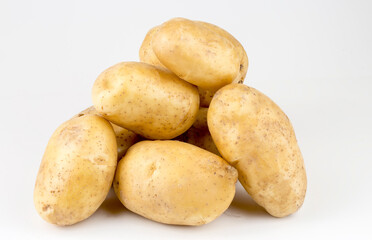 Fresh organic vegetables; potatoes on the white background.