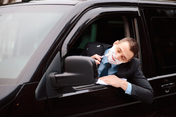Fototapeta na wymiar Businessman shaving in car by razor and foam at the wheel. Shaving man in the driver's seat. Hurring. Bluer collar office employee shaveing himself in heavy traffic jam.Beautiful Man in suit