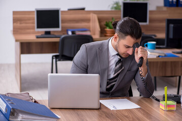 Young male employee working in the office