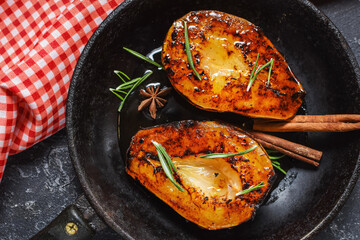 Caramelized pears with spices in syrup on a saucepan. Tasty dessert for holiday.
