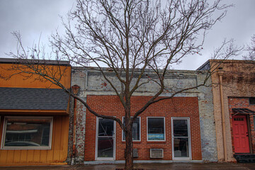 Brick building and a tree in the Fall with rustic lamp