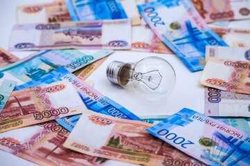 Calendar and money. Light bulb and Ruble bills.