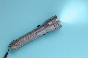 led flashlight on a blue surface