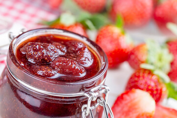 Bowl of strawberry jam isolated on white background from top view