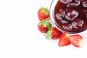 Bowl of strawberry jam isolated on white background from top view