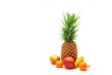Fototapeta na wymiar Pineapple surrounded by fruit with white background and copy space