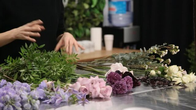 girl florist prepares flowers for making a bouquet of flowers