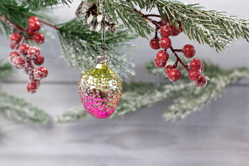 Old soviet decoration on the Christmas tree, glass toy strawberry close up on light background
