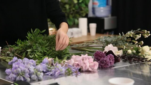 girl florist prepares flowers for making a bouquet of flowers