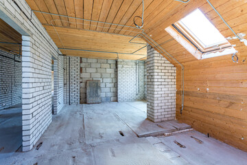 empty interior in house without repair on wooden mansard  floor and brick wall
