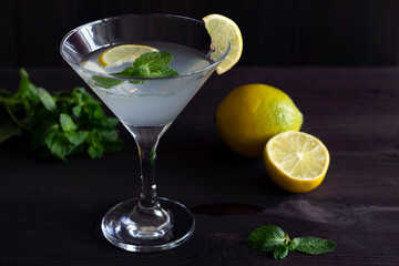 close-up cocktail mojito. Martini glass with cocktail and olives on black background. Margarita cocktail with lime and green mint on the wooden table. copy space. alcohol drinks.