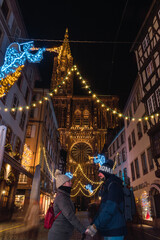 Couple in love near Strasbourg cathedral at Christmas
