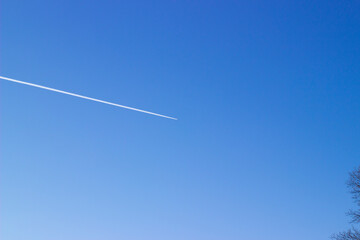 Blue skyPlane trail in the blue sky