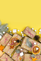 Many craft gift boxes on yellow background. Christmas banner template. New year zero waste still life