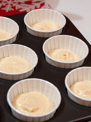 Dough for cupcakes in white feeds. Selective focus.