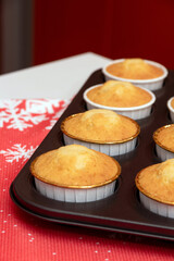 A portion of fresh baked cupcakes in the form of stand on the table. Selective focus.