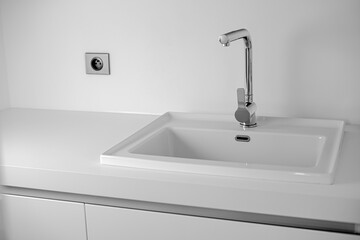 Modern bathroom interior with sink and chrome faucet.