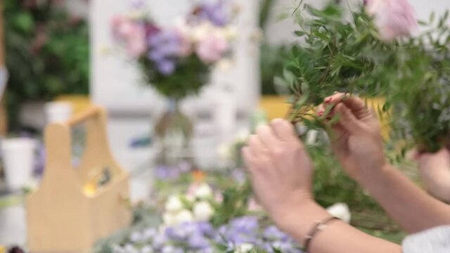 girl florist prepares flowers for making a bouquet of flowers