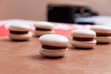 Obraz na płótnie Canvas Five white macaroons with chocolate cream. Selective focus.