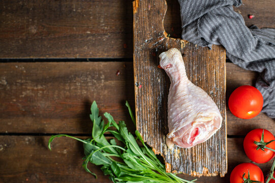 Chicken leg raw meat skin bones broiler fresh piece ready to eat on the table healthy meal snack ingredient top view copy space for text food background rustic