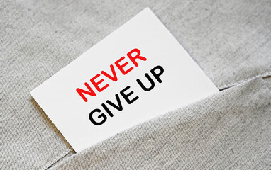 Motivational phrase, never give up, written on white sticker in the shirt pocket