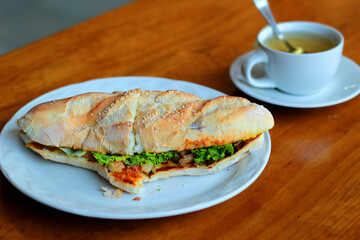 baguette and tea on a wooden table in a restaurant