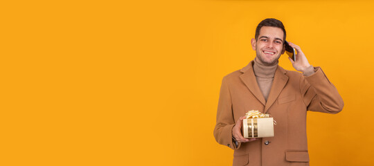 man with gift box and mobile phone isolated