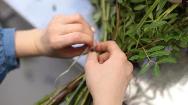 girl florist prepares flowers for making a bouquet of flowers