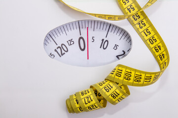 scale with tape measure in concept of diet and lose weight